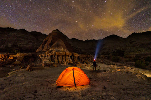 Tent Glowing Amongst Red Rock Hoodoo Formations at Night