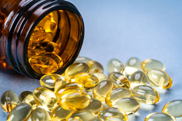 istock Omega 3 or nutritional supplement pills spilling out from bottle 1315890134