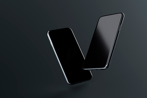 Two smartphones with blank screen soaring on dark background. Stylish mockup for your web site design or mobile application.