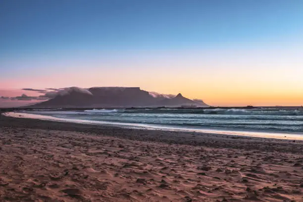 View of Table Mountain and Cape Town city coastline at sunset, Cape Town, South Africa from Blouberg Beach