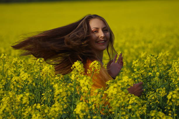 istock Beautiful young woman in rapeseed field 1315894007