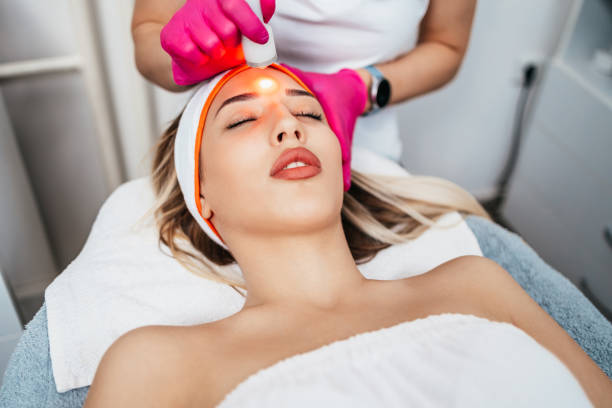 Face treatment Beautiful and attractive adult woman receiving professional facial care steam beauty treatment laser stock pictures, royalty-free photos & images