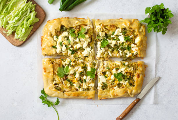 istock Open face vegetable pie with cabbage, potatoes, feta and greens close up 1315902525