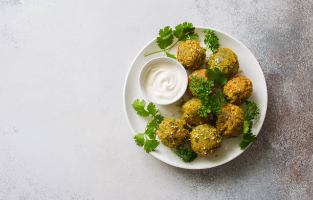 palline di falafel arrosto fatte in casa con verdure e salsa allo yogurt - roasted sesame seeds foto e immagini stock