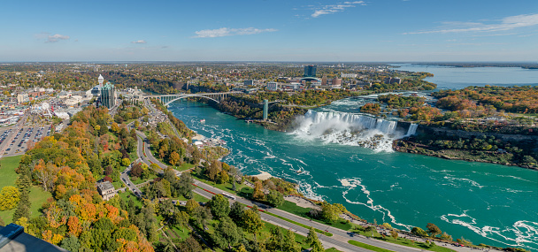 Niagara Falls, Canada - October 20, 2019: Aerial view of Rainbow bridge  and Niagara Falls in a sunny autumn day