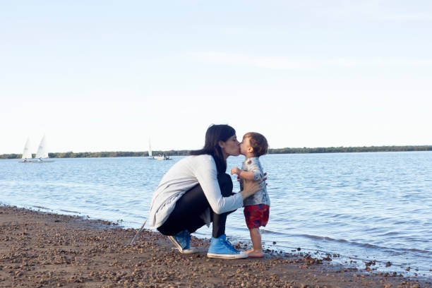 istock mother and children playing in the river 1315912074