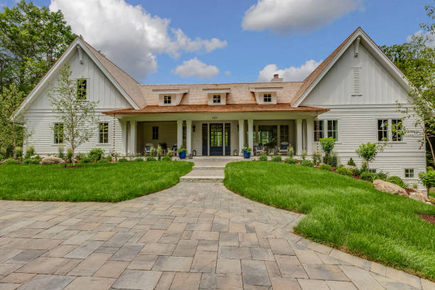 istock Stone paved front walkway of new home with three small dormer windows 1315912165