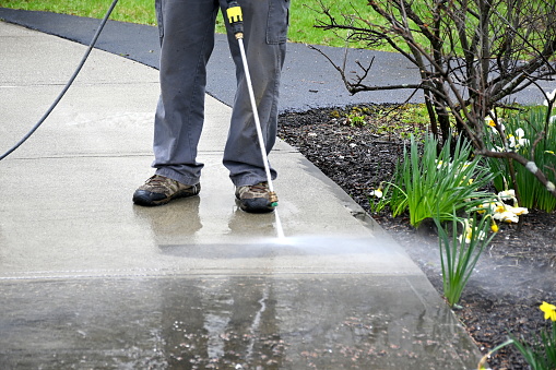 man clean path. Pearson uses power washer, spring cleaning