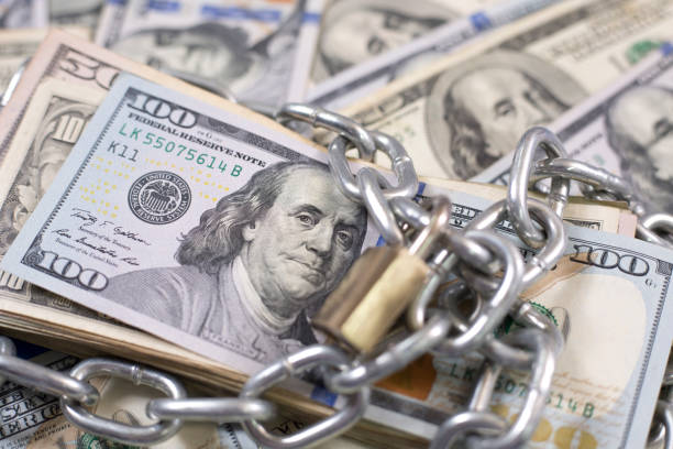 istock American paper currency under lock and chain. 1315918072
