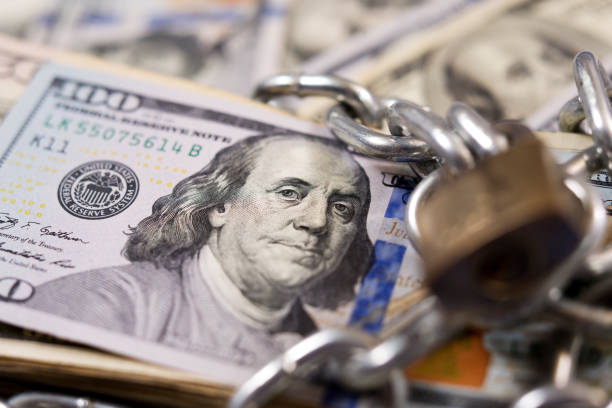 istock American paper currency under lock and chain. 1315918083