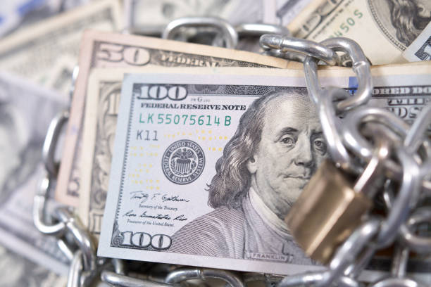 istock American paper currency under lock and chain. 1315918099