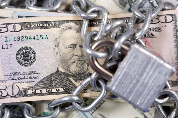 istock American paper currency under lock and chain. 1315918147