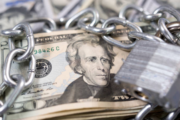 istock American paper currency under lock and chain. 1315918166