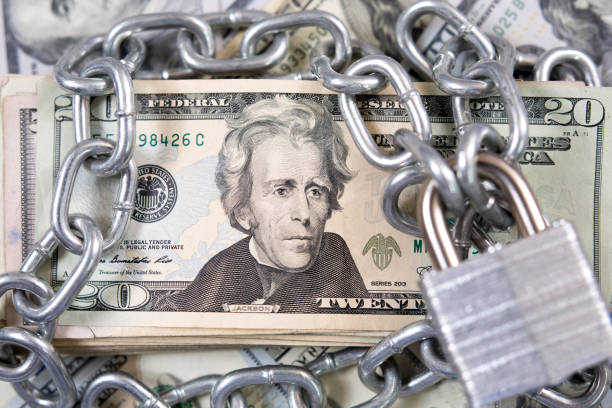 istock American paper currency under lock and chain. 1315918203