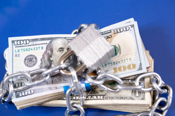 istock American paper currency under lock and chain. 1315918247