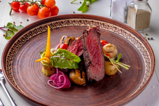 istock Filet mignon served with grilled vegetables and mushrooms, restaurant dish, Horizontal orientation 1315919274