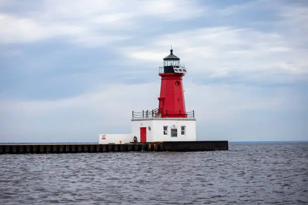Menominee North Pier Lighthouse "Menominee (Marinette) North Pierhead Light" in Menominee, Michigan on the waters of Lake Michigan and the Menominee River in May, horizontal