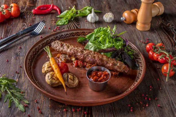 Turkish and Arabic Traditional Ramadan mix kebab plate, Kebab beef with baked vegetables, mushrooms and tomato sauce, Closeup, Horizontal photo