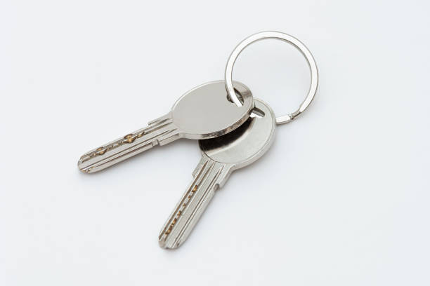 Three keys to the apartment. Close up of keys on a white background