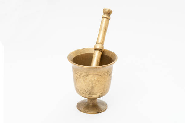 Antique and aged pestle and mortar on the white background.