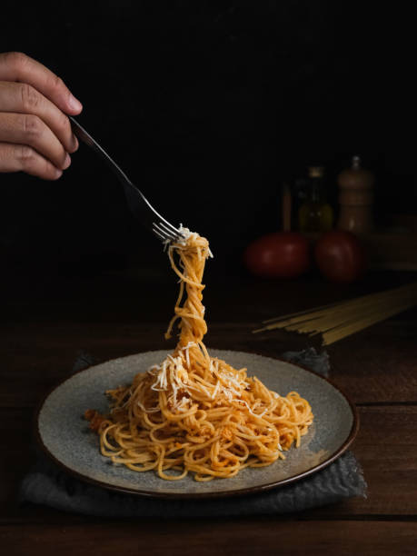 istock Delicious spaghetti bolognese served on a plate, with blurred and dark background. 1315933843