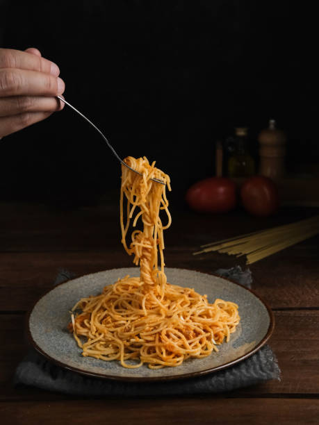 istock Delicious spaghetti bolognese served on a plate, with blurred and dark background. 1315933844
