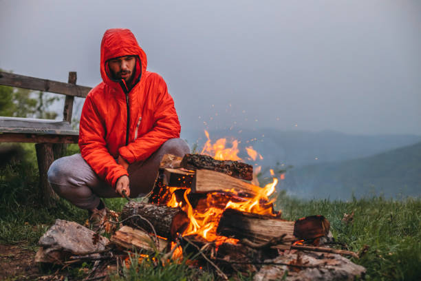 istock Man lights a campfire in the mountains 1315935748