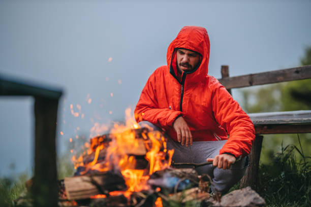 istock Man lights a campfire in the mountains 1315935756