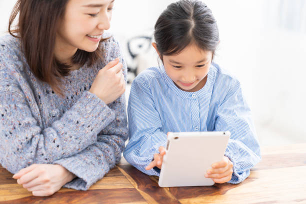istock asian mother and daughter,tablet computer 1315939354