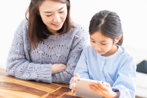 istock asian mother and daughter,tablet computer 1315939416
