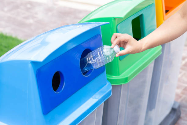 istock Close up hand holding garbage plastic bottle into recycle trash bin, selective focus 1315960116