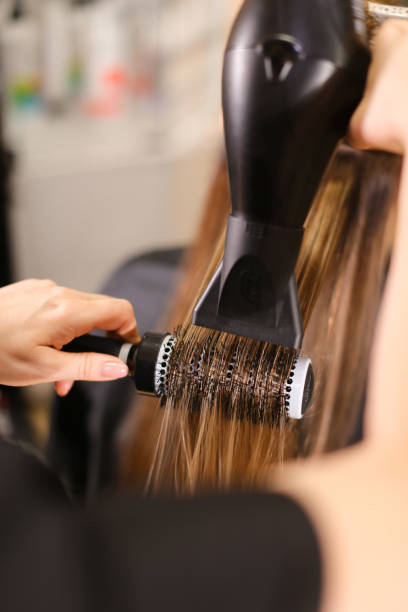 istock Stylist doing hairstyle beautiful brunette 1315960807