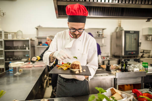 istock Chef serves the food on a plate 1315965928