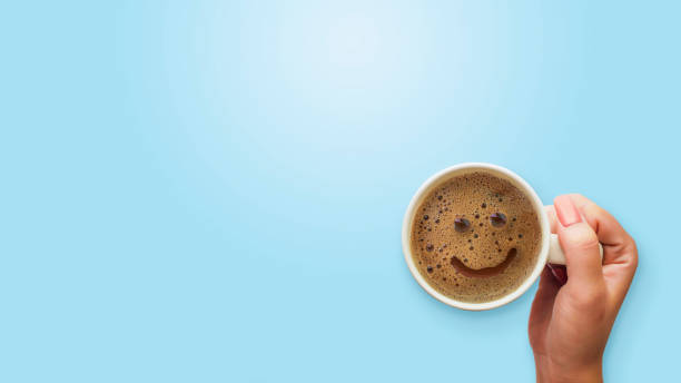 froth milk foam smiles in a cup of coffee in morning. stock photo