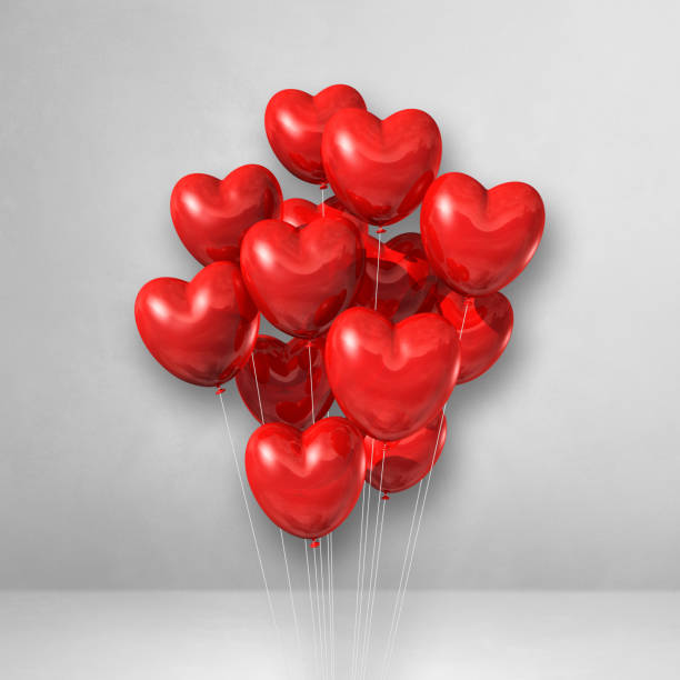 istock Red heart shape balloons bunch on a white wall background 1315969718