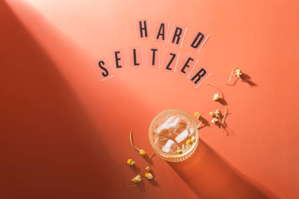 Hard seltzer cocktail with chamomile and ice Hard seltzer cocktail with chamomile and ice on a table. Summer refreshing beverage, drink soda water glass lemon stock pictures, royalty-free photos & images