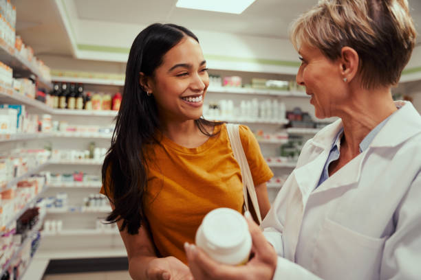 Senior pharmacist assisting of buying medical drug to buyer in pharmacy drugstore Senior pharmacist assisting in buying medical drug to buyer in pharmacy chemist stock pictures, royalty-free photos & images