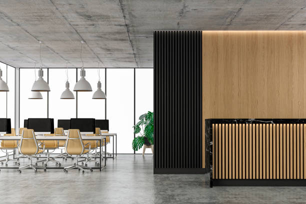 istock Empty office interior with copy space and wordesks and reception desk on concrete floor 1315974784