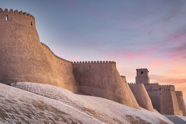 Khiva City Walls Uzbekistan in Colorful Sunset Twilight Хива Chiva Majestic ancient historic city walls of the old town of Khiva under beautiful colorful sunset twilight. Ancient City Walls Khiva, Itchan Kala, Khiva - Chiva - Хива, Xorazm Region, Uzbekistan, Central Asia khiva stock pictures, royalty-free photos & images