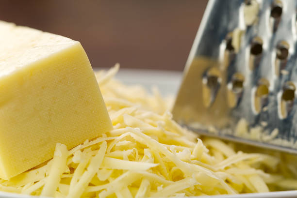 Cheese and Grated cheese, close-up. blurred background