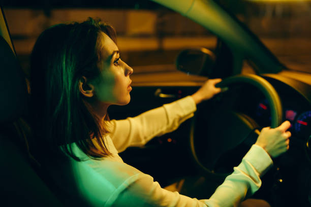 istock Young woman going on a road trip by car at night. 1315976783