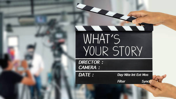 What's your story.text title on film slate and film crew in background What's your story.text title on film slate and film crew in background producer stock pictures, royalty-free photos & images