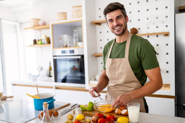 istock Happy caucasian man cooking in kitchen at home, smiling. 1315982363