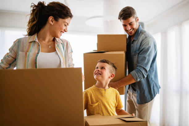 istock Family unpacking cardboard boxes at new home 1315982430