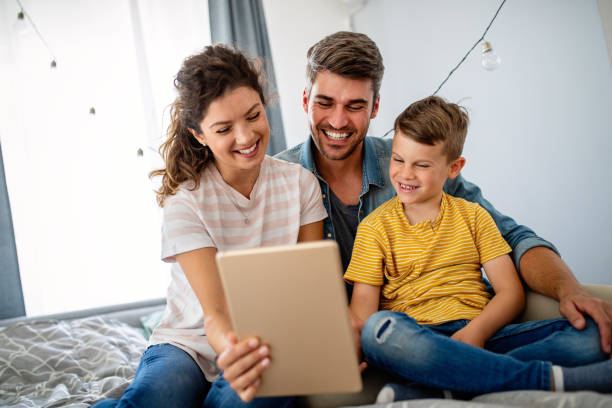 istock Happy family using technology devices together at home. 1315982517