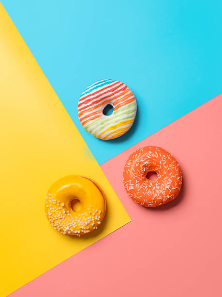 istock Glazed donuts on colorful background, top view 1315989623