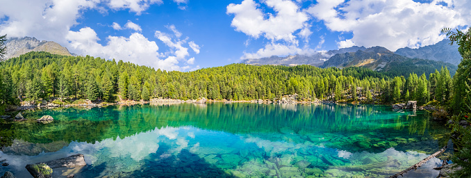 Idyllic nature scenery- turquoise mountain lake Carezza surrounded by Dolomites rocks- one of the most beautiful lakes of Alps. South Tyrol region. Italy