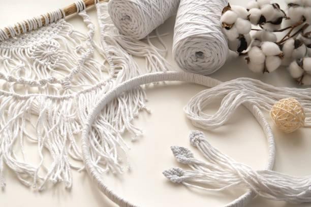 Workspace with white threads and cords for macrame. Boho and eco concept. Workspace with white threads and cords for macrame. Boho and eco concept. macrame photos stock pictures, royalty-free photos & images