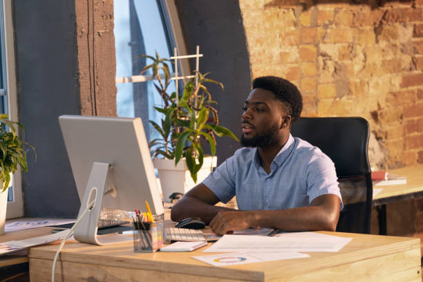 istock African businessman, manager working in modern office using devices and gadgets 1315999982