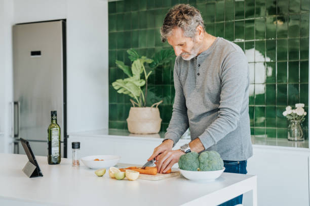 istock Man Follows Recipe On Digital Tablet In Kitchen Shot 1316001550